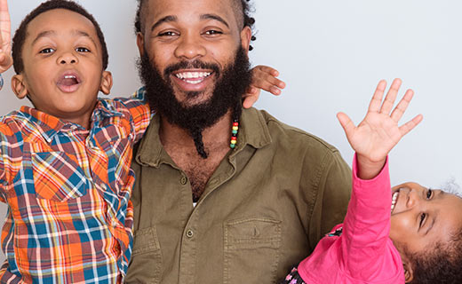 holding holding two children and smiling