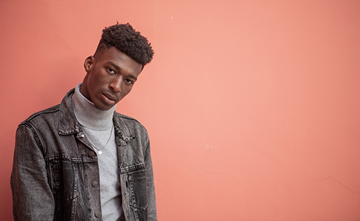 fashion model posing against back drop wall