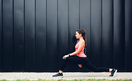 Woman stretching her legs wearing work out gear