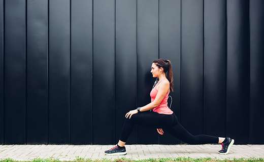 Woman in yoga wear, stretching.