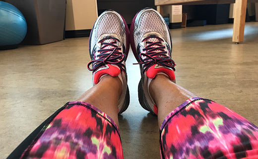 woman sitting with sneakers on