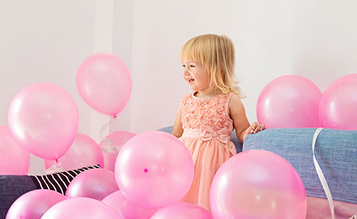 Little girl with pink balloons ready for photo shoot