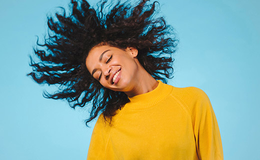 Woman in gold shirt smiling