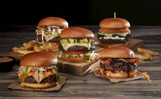 Variety of hamburgers shown with fries