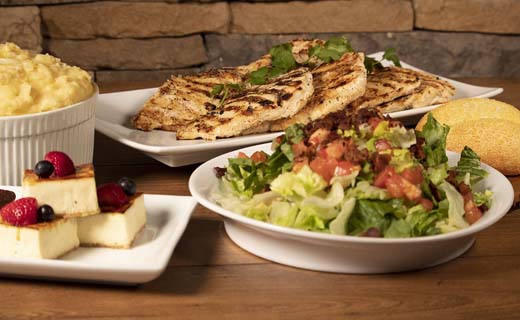 Shown: family meal salad, chicken entrée, side, bread and dessert
