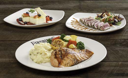 Grilled Salmon, Seared Ahi Tuna and Creme Brulee Cheesecake on white plates.