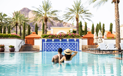 A couple enjoying a luxurious pool in Scottsdale