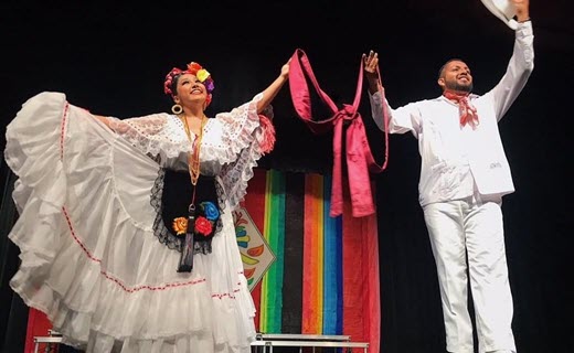 woman and man dressed in traditional mexican folk dance costumes