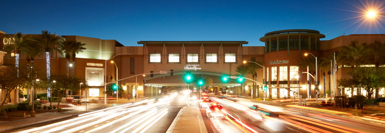 Traffic driving by Scottsdale Fashion Center at night