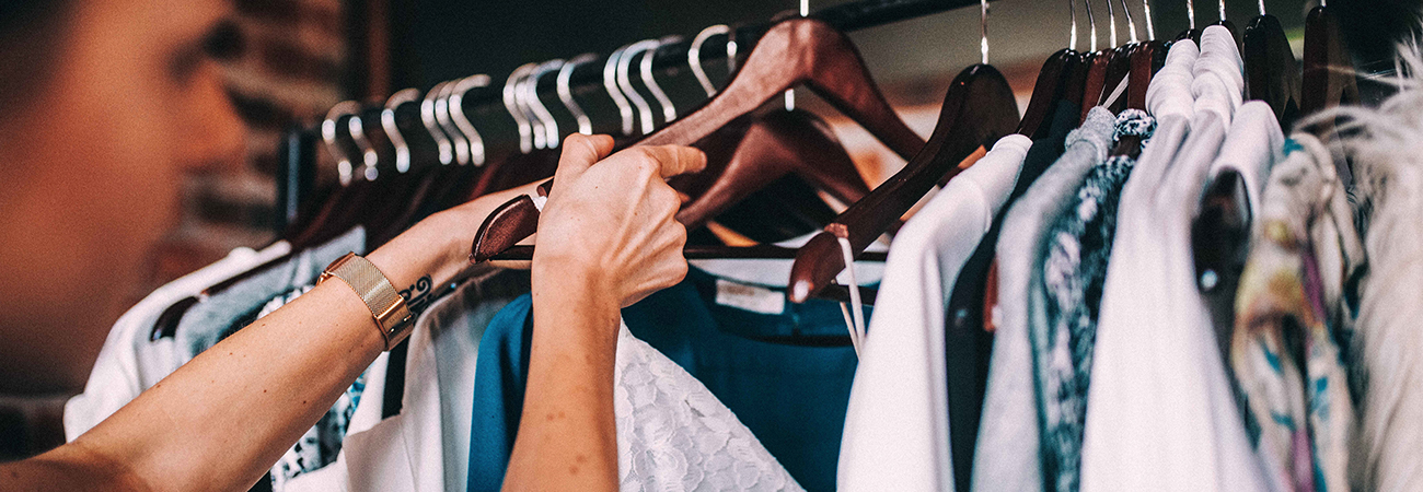 Hanging clothes on wooden hangers