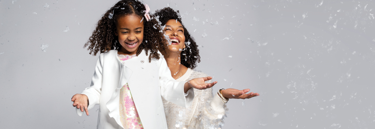 Woman and girl smiling and laughing.