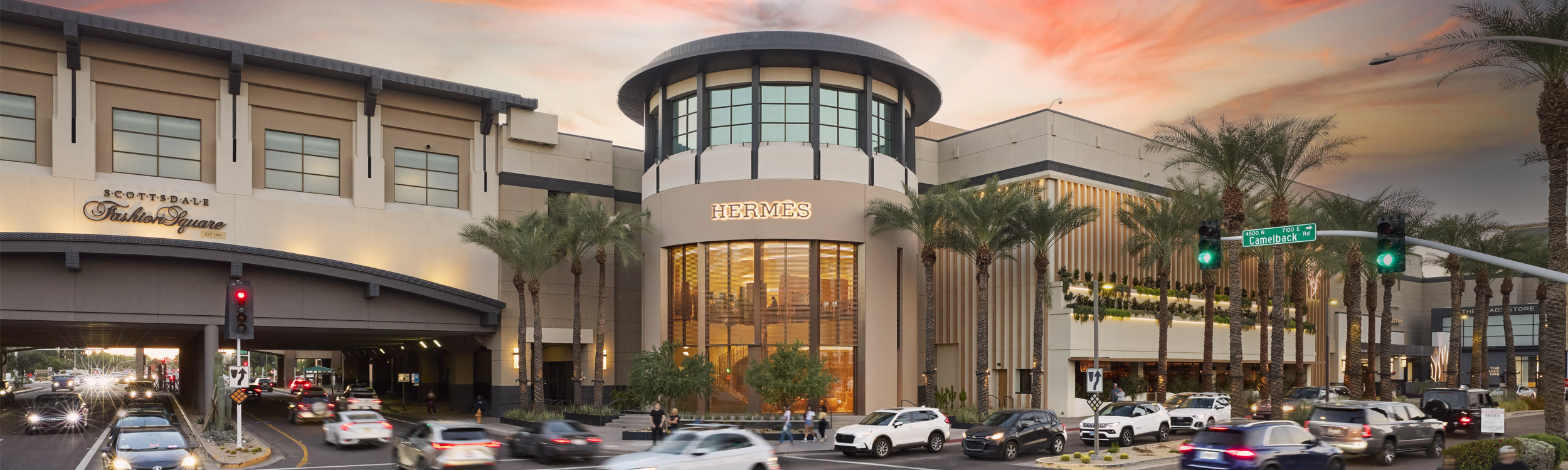 A view of the exterior of Scottsdale Fashion Square at dusk looking toward Hermes