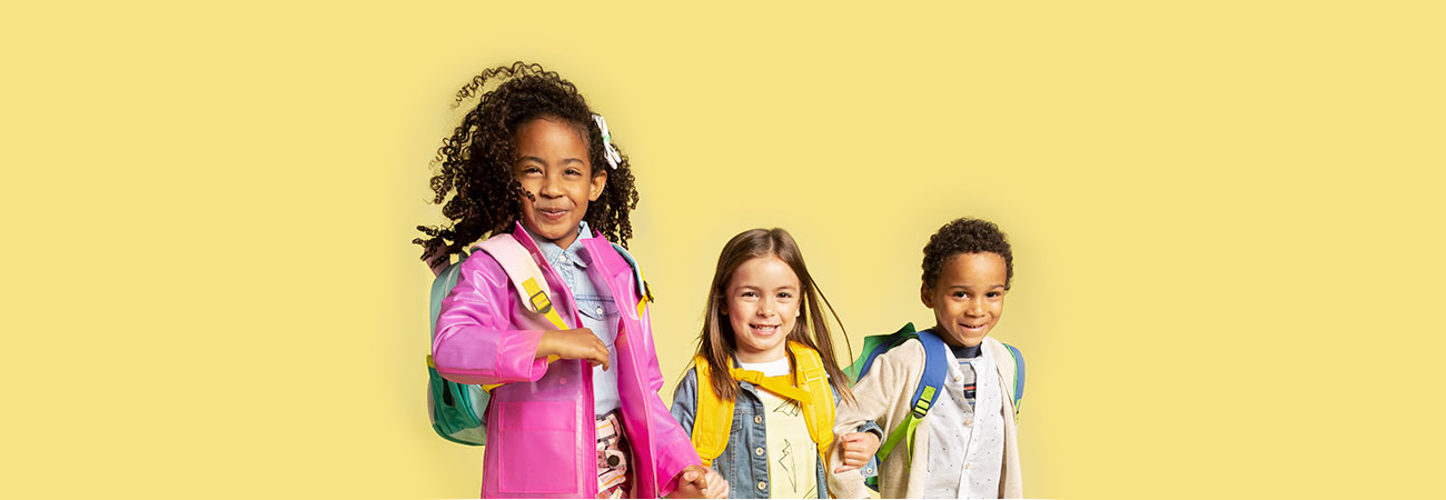 three kids - one girl wearing pink raincoat, girl wearing denim jacket and little boy