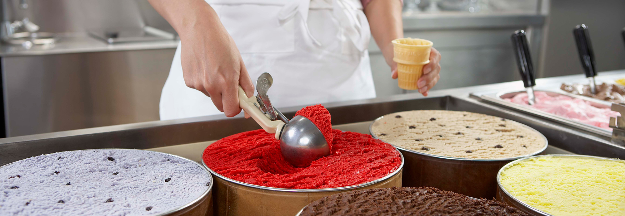A woman scooping ice cream