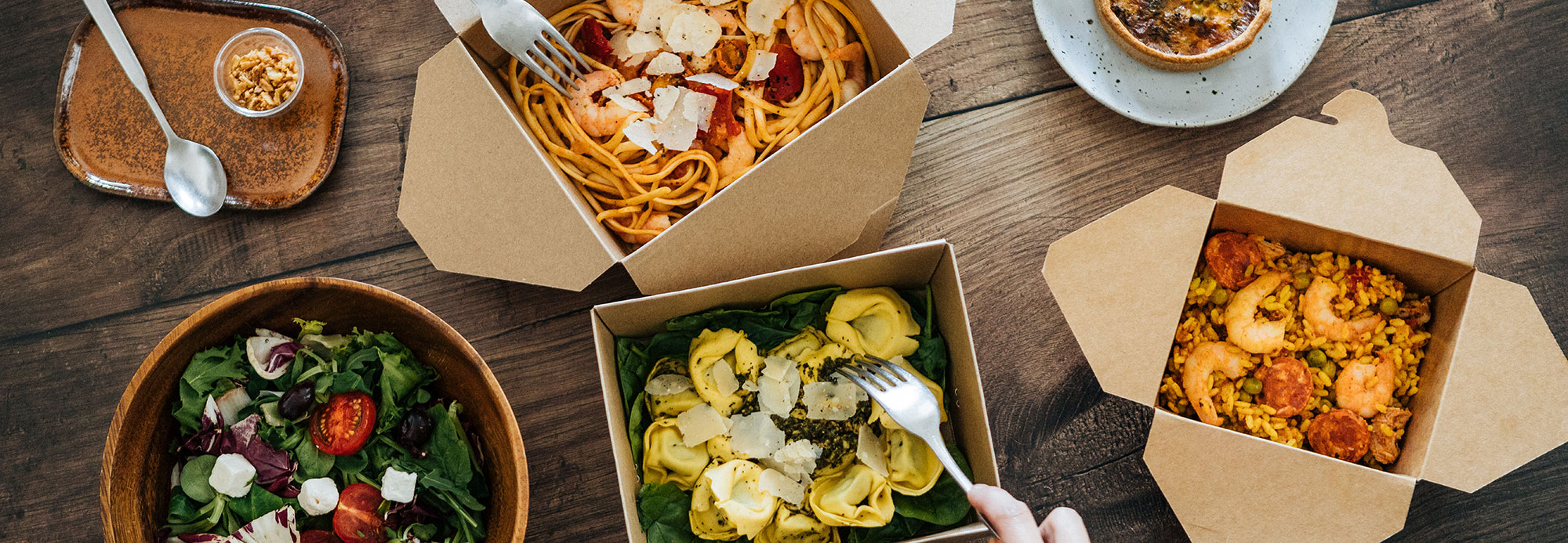 Various takeout foods served on a table