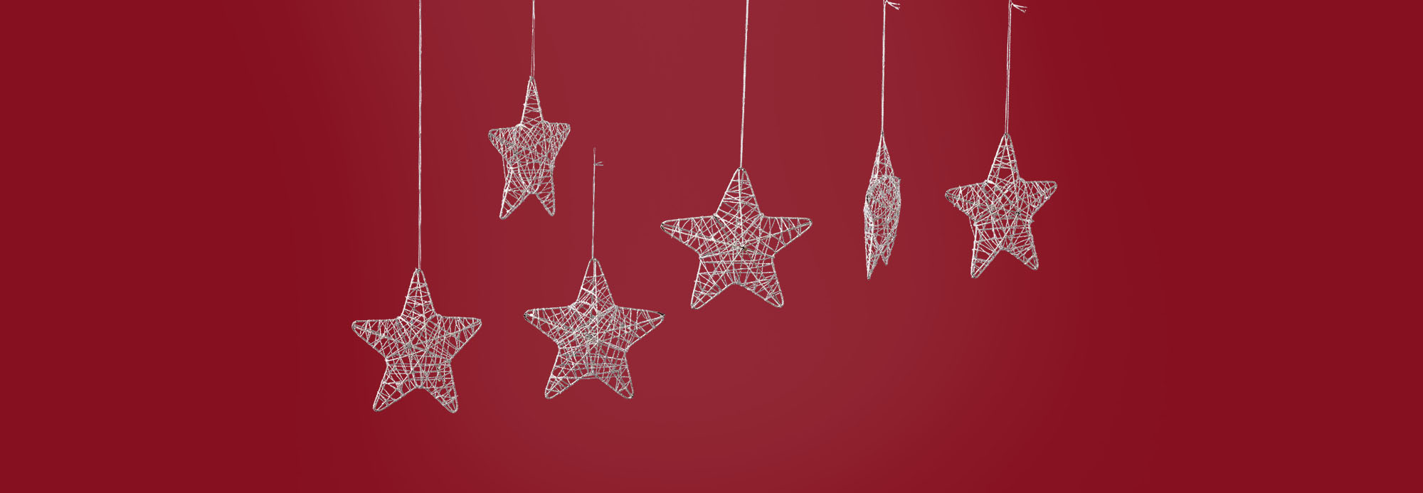 Illustrated star ornaments handing in front of a red background