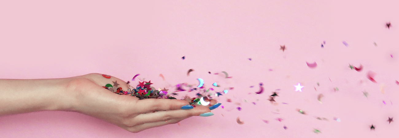 Confetti blowing out of a hand