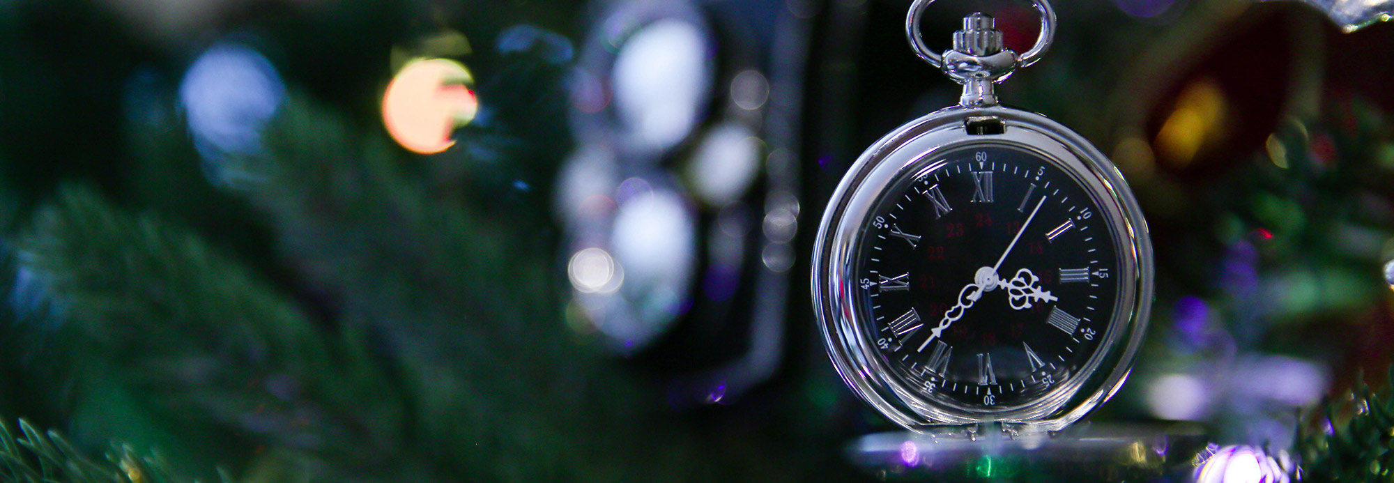 Santa's silver watch ornament on the tree