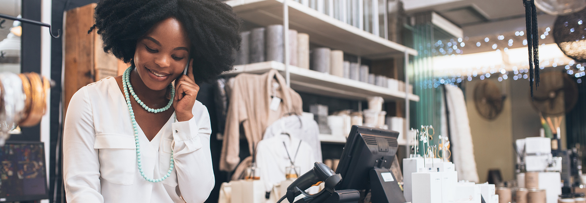 A sales associate working at a cash register station