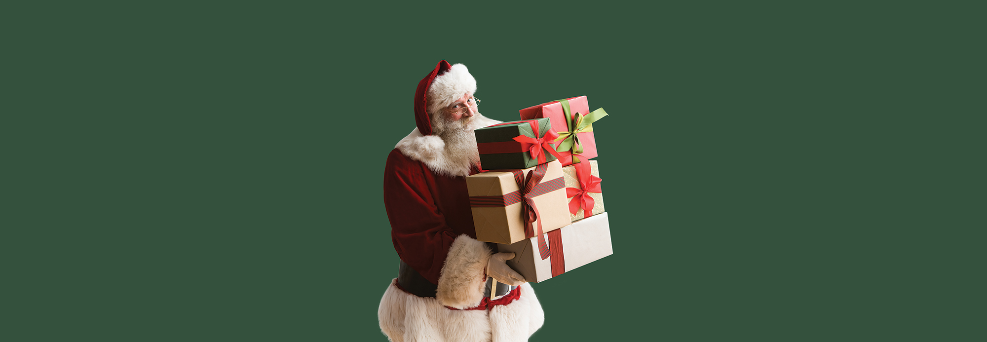 Santa carrying a pile of presents