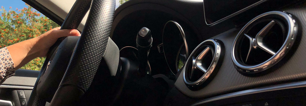 Hand on steering wheel
