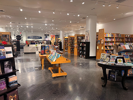Bookshelves filled with colorful books in a bookstore with a nice display stands
