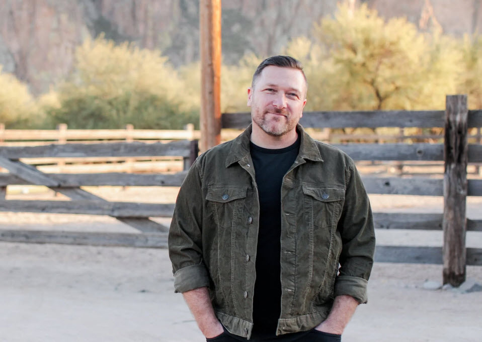 man in front of a fence
