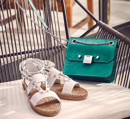 Jimmy Choo White Sandals and Green Purse on a chair