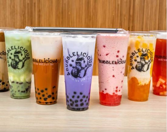 Seven colorful boba drinks lined up