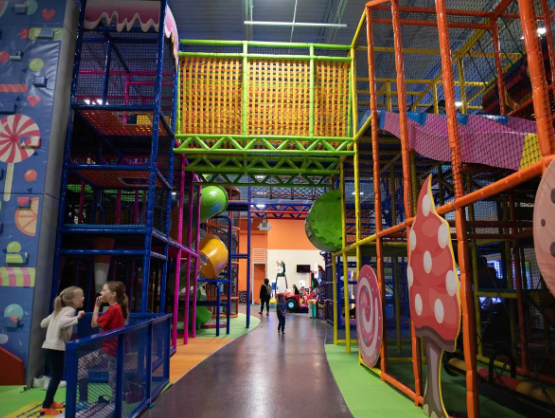 An indoor play structure in colorful hues and Candyland theme
