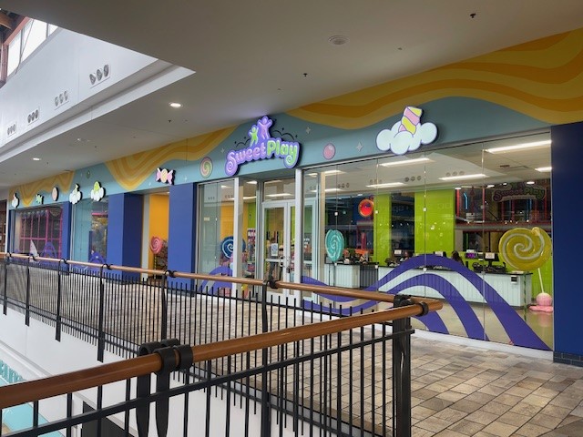 An indoor play structure in colorful hues and Candyland theme