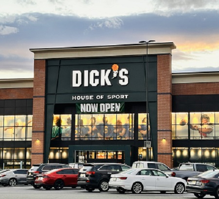 Front of Dick's House of Sport with a Now Open banner and cars in the lot