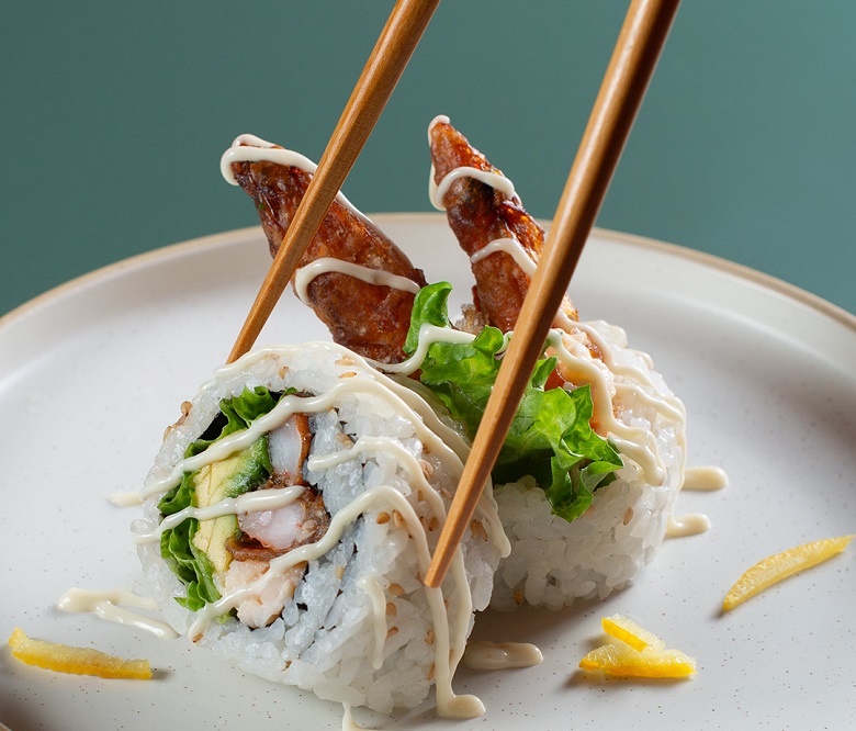 Shrimp Tempora sushi on a plate with chopsticks
