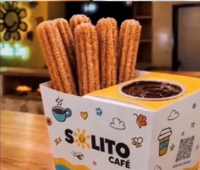 2 to-go coffee cups in a cup holder on a restaurant counter