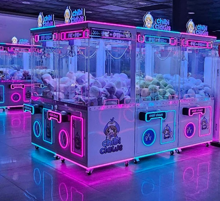 Neon-lit claw machines filled with colorful stuffed toys