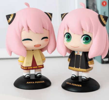 2 collectible girl figurines with pink hair