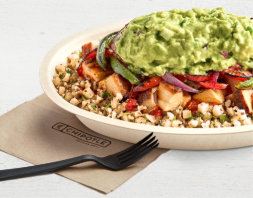 Rice bowl with corn, chicken, and topped with guac