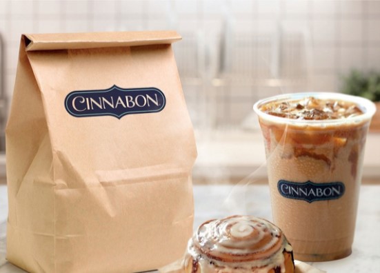brown paper bag and iced coffee cup with cinnabon logo and small cinnabon