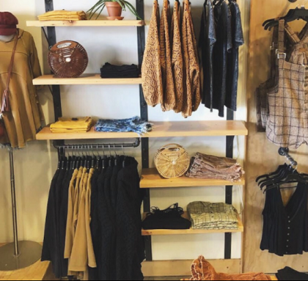 Clothing hanging on racks and shelves