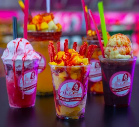 Cups filled with a variety of ice cream flavors.