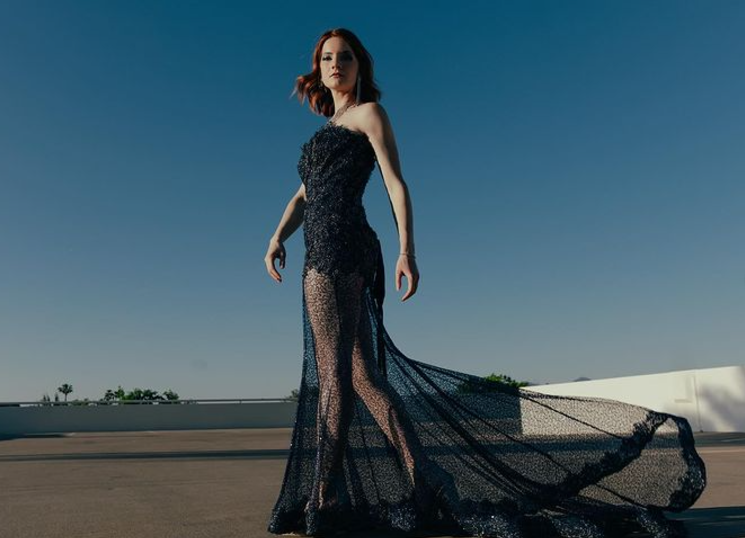 Model posing in blue gown