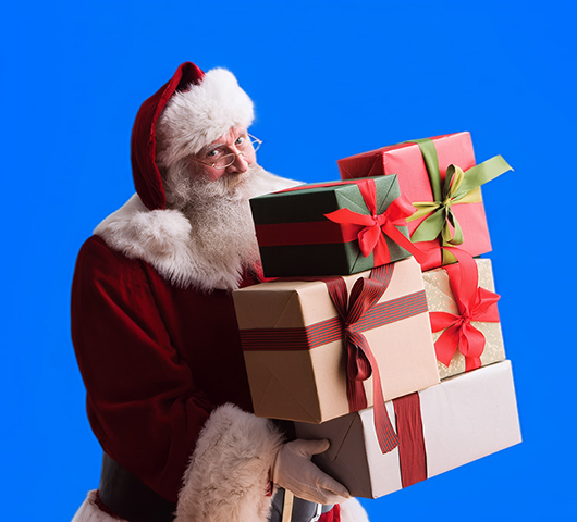 Santa holding a stack of presents