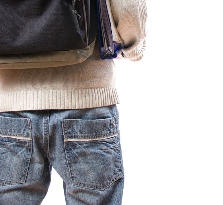 male student with jeans and backpack
