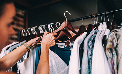 Woman handing clothes on a rack