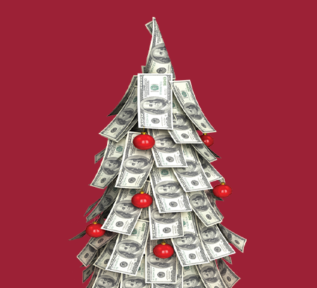 Hundred dollar bills on a christmas tree with red ornaments