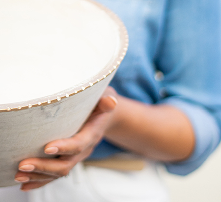 Woman holding a beach-inspired bowl