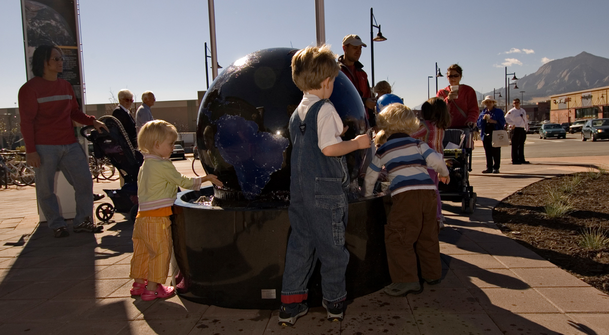 Group of kids playing with a globe at Twenty Ninth Street
