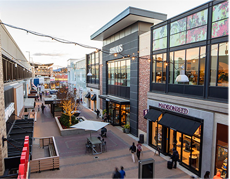 Aerial view of the stores at Broadway Plaza at dusk