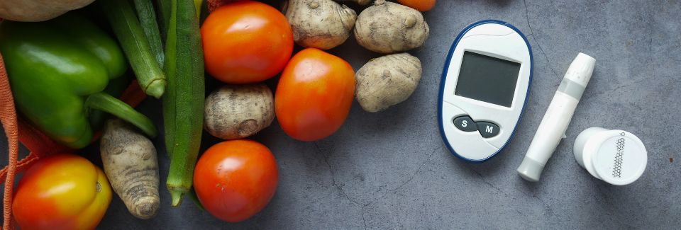Vegetables show with a glucose monitor, a needle pen and test strips.