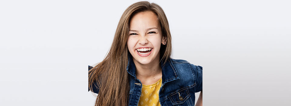 Girl in elementary school smiling at the camera